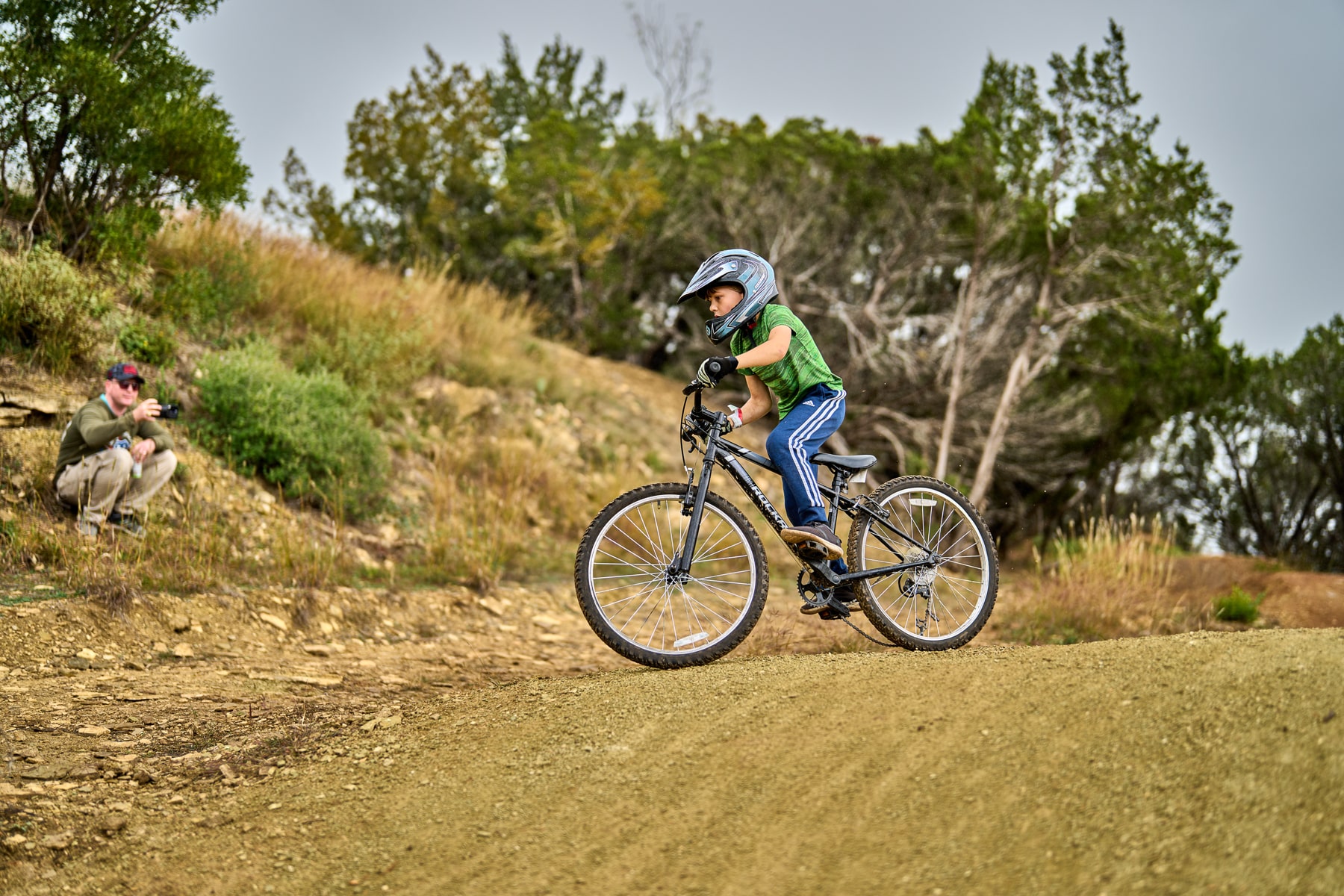 Little kid riding a bike on a smooth trail.