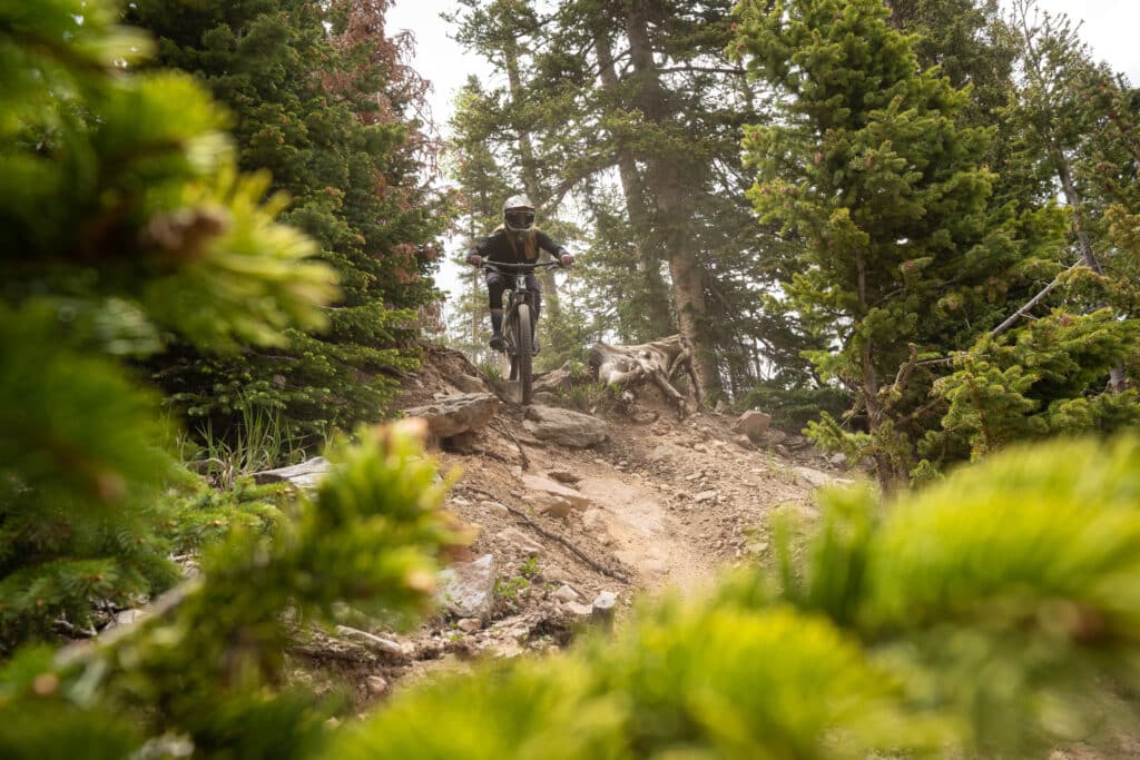 Biker going down a trail at Pajarito Bike Park in New Mexico