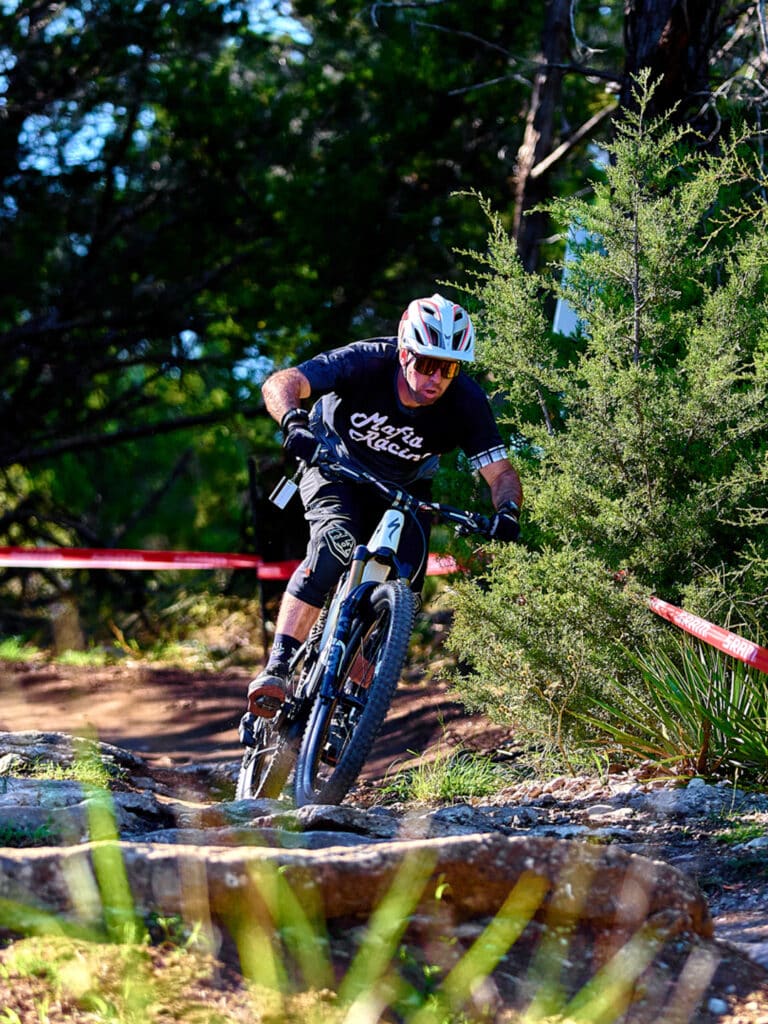 Rider cruising down a singletrack at Spider Mountain Bike Park