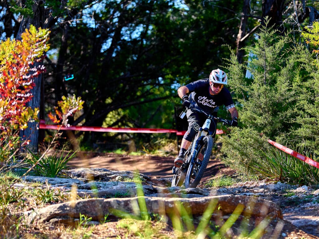 Rider cruising down a singletrack at Spider Mountain Bike Park